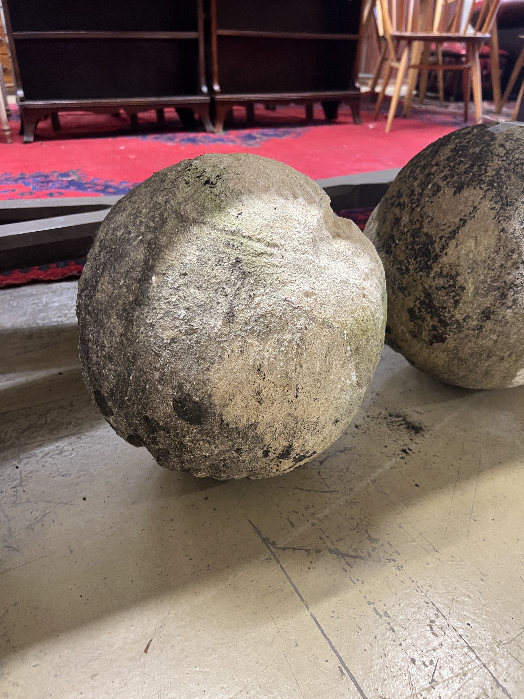 A trio of graduated reconstituted weathered stone ball finials, largest height 37cm